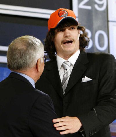 Adam Morrison shakes hands with NBA commissioner David Stern after being drafted third overall by Charlotte. 
 (Reuters / The Spokesman-Review)