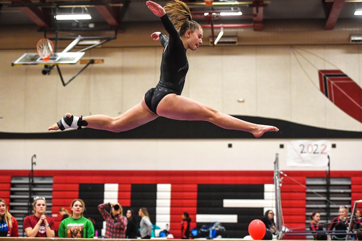 Mead gymnast Lexi Weller flies above the balance beam during competition at North Central High School, Thursday, Dec. 13, 2018 in Spokane, Wash. (Dan Pelle / The Spokesman-Review)