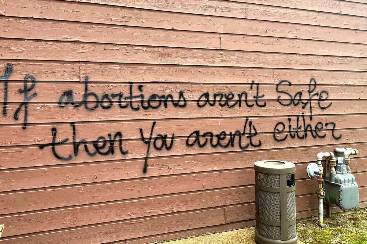 Threatening graffiti is seen on the exterior of Wisconsin Family Action offices in Madison, Wis., on Sunday, May 8, 2022. The Madison headquarters of the anti-abortion group was vandalized late Saturday or early Sunday, according to an official with the group.  (Alex Shur)