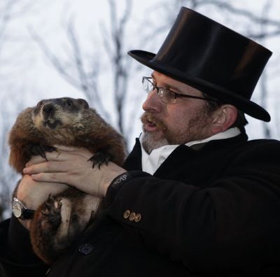 Ben Hughes, handler of the weather-predicting groundhog Punxsutawney Phil, holds Phil after removing him from his stump at Gobbler's Knob on Groundhog Day, Feb. 2, 2009, in Punxsutawney, Pa. The Groundhog Club said Phil saw his shadow and predicted six more weeks of winter. (Associated Press)
