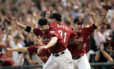 The Houston Astros rush the field to celebrate an 18-inning Game 5 victory over the Atlanta Braves.
(Associated Press / The Spokesman-Review)