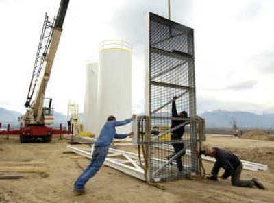 
Ray Dreo, Kevin Pack and Dan Huls, from left, assemble a stairway next to the methane-producing tanks at Huls dairy near Corvallis, Mont. on Nov. 8. Associated Press
 (Associated Press / The Spokesman-Review)