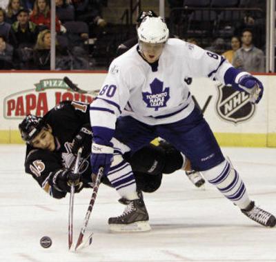 
 Toronto's Nik Antropov, right,  battles for control of the puck.
 (Associated Press / The Spokesman-Review)