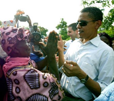 
U.S. Sen. Barack Obama claps hands with his grandmother, Sarah Hussein Obama, at his father's house in Nyongoma Kogelo village, western Kenya during a visit on Saturday. 
 (Associated Press / The Spokesman-Review)