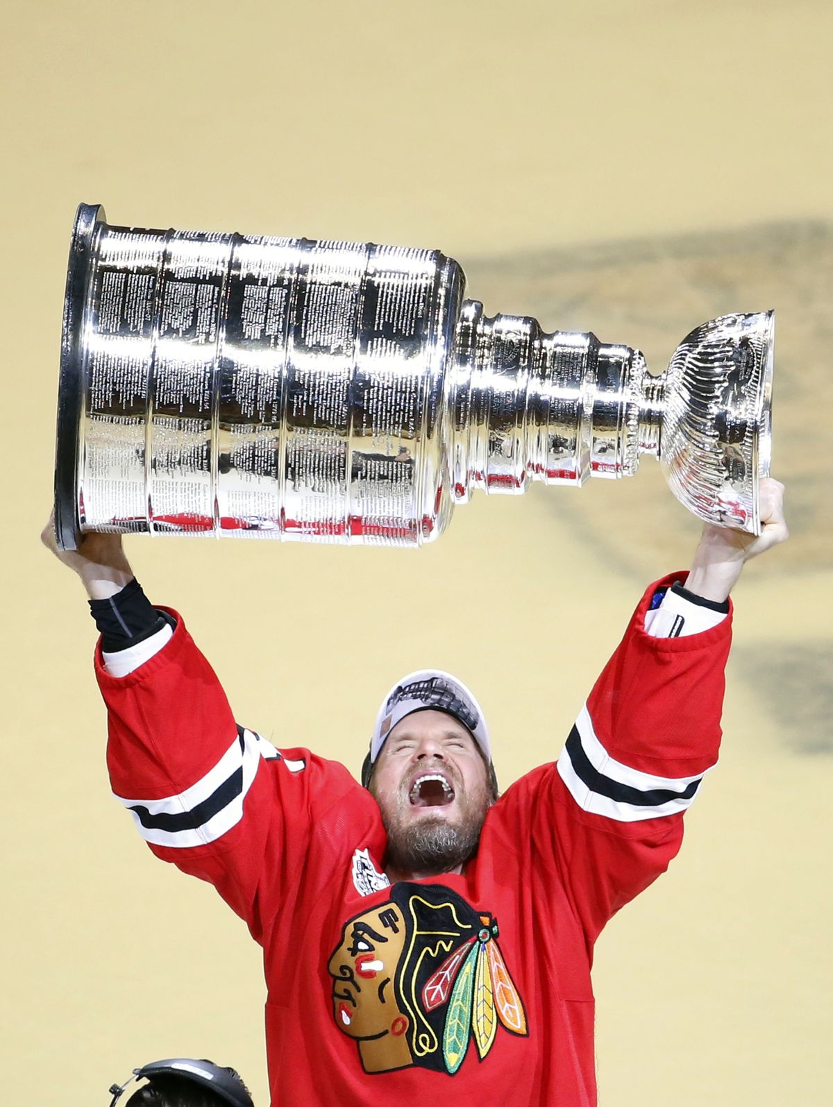 In what was likely his final game of a 16-year NHL career, Kimmo Timonen triumphantly hoists Stanley Cup after Chicago’s 2-0 win on Monday. (Associated Press)