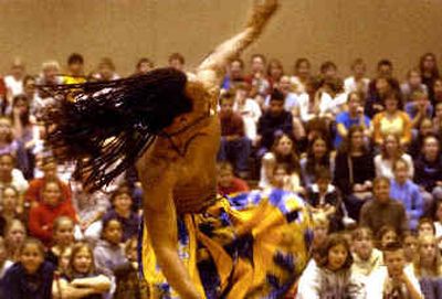 
Rainbow Dance Theatre director Darryl Thomas performs a dance from Ghana called Gahoon for students at Horizon Middle School Friday afternoon. The Portland-based dance company presented an educational cultural experience called  