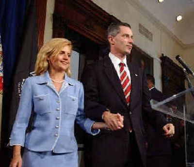 
New Jersey Gov. James E. McGreevey holds his wife Dina Matos McGreevey's hand, before announcing he will resign, during a news conference Thursday at the Statehouse in Trenton, N.J., 
 (Associated Press / The Spokesman-Review)