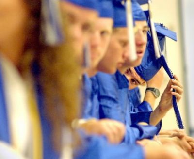 In this June 5, 2003, SR file photo by Jesse Tinsley/SR, restless 2003 graduates fidget while waiting for photographer Norm See to shoot their class photo Thursday before getting final instructions about graduation from principal Steve Casey at Coeur d'Alene High.