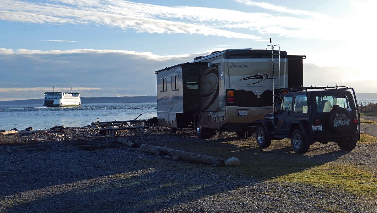 The sun sets over Admiralty Inlet as campers at Fort Casey State Park watch the Port Townsend Ferry come and go. (John Nelson)