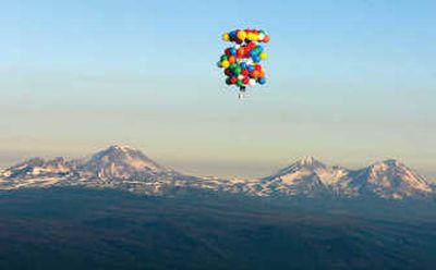 
Balloons suspend Kent Couch in a lawn chair as he floats  near Bend, Ore., on Saturday.  He carried a global positioning system device, a two-way radio, a digital camcorder and a cell phone. Associated Press
 (Associated Press / The Spokesman-Review)