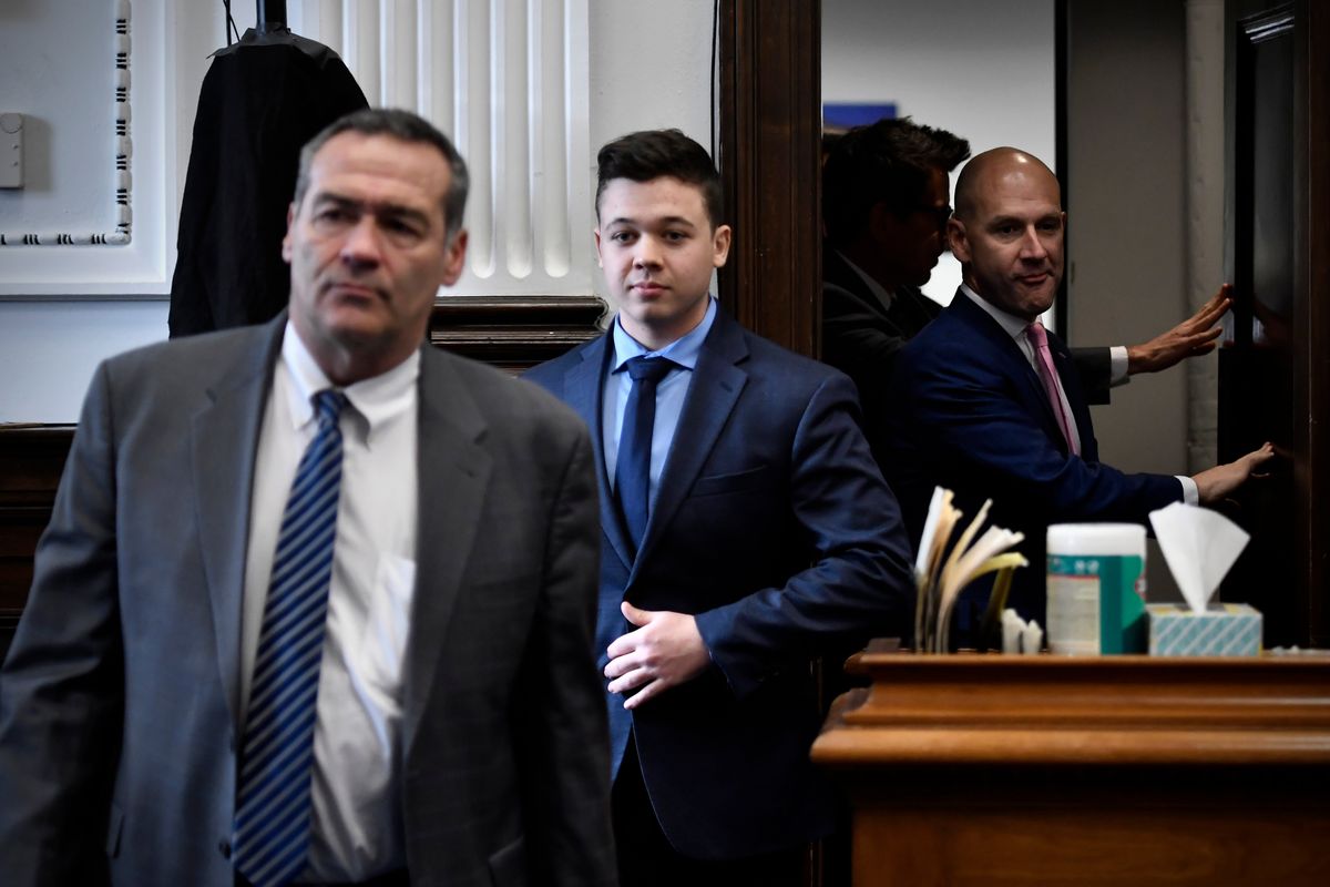 Kyle Rittenhouse, center, enters the courtroom with his attorneys Mark Richards, left, and Corey Chirafisi for a meeting called by Judge Bruce Schroeder at the Kenosha County Courthouse in Kenosha, Wis., on Thursday, Nov. 18, 2021.  (SEAN KRAJACIC)
