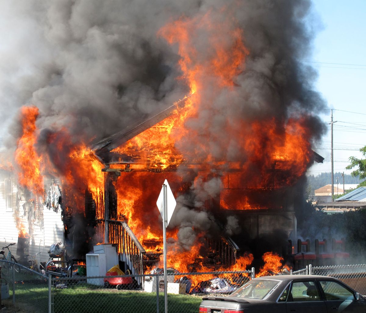 Fire engulfs the front end of a rental house on the 5400 block of east Commerce, July 2, 2009 in Spokane, Wash.  Kate Williams, a neighbor from across the street, snapped the photo with her digital camera.    (Kate Williams / Courtesy photo)