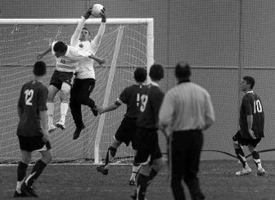 
East Valley goalkeeper Josh Peck robs Cameron Bushey (10) of a score en route to a 3-0 shutout of host Mead Friday. 
 (Jed Conklin / The Spokesman-Review)