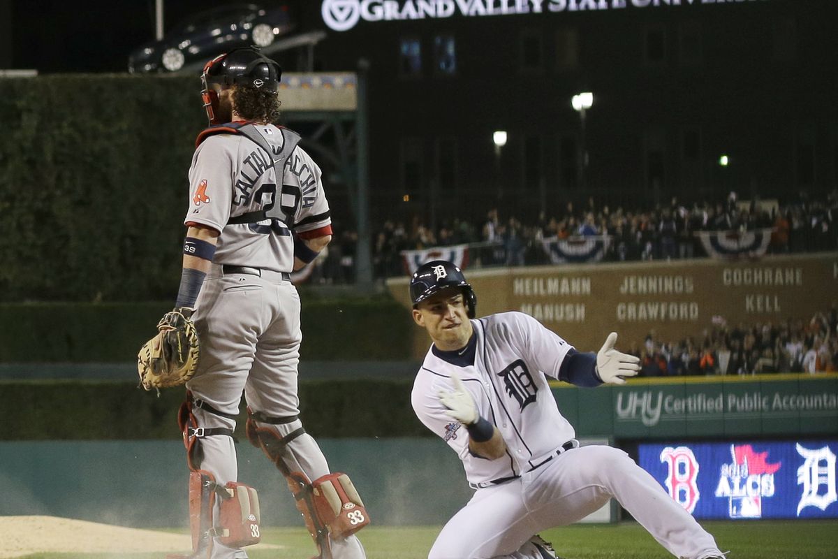 Detroit’s Jose Iglesias scores on a double by Torii Hunter in the the Tigers’ five-run second inning during Game 4 of the ALCS. (Associated Press)