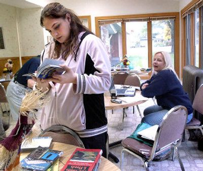 
Bethany Place activities director Sarah Berring looks  at some of the books and movies available through the Spokane County Library District outreach program.
 (Joe Barrentine / The Spokesman-Review)