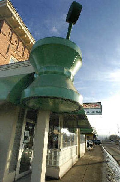 
A sign from the old pharmacy still hangs at the corner of Hamilton and Mission where Jack and Dan's Bar and Grill has expanded. 
 (CHRISTOPHER ANDERSON / The Spokesman-Review)