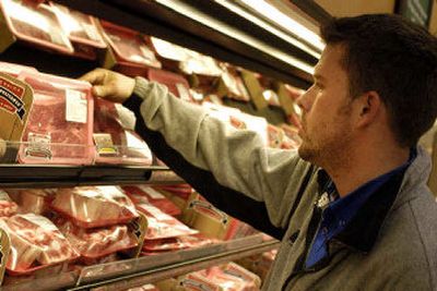 
Dan Hogan looks for a good cut of meat at the Cub Foods grocery store in Burnsville, Minn. Through research, the company discovered that eight of 10 shoppers were baffled by the meat case at their stores. 
 (Associated Press / The Spokesman-Review)