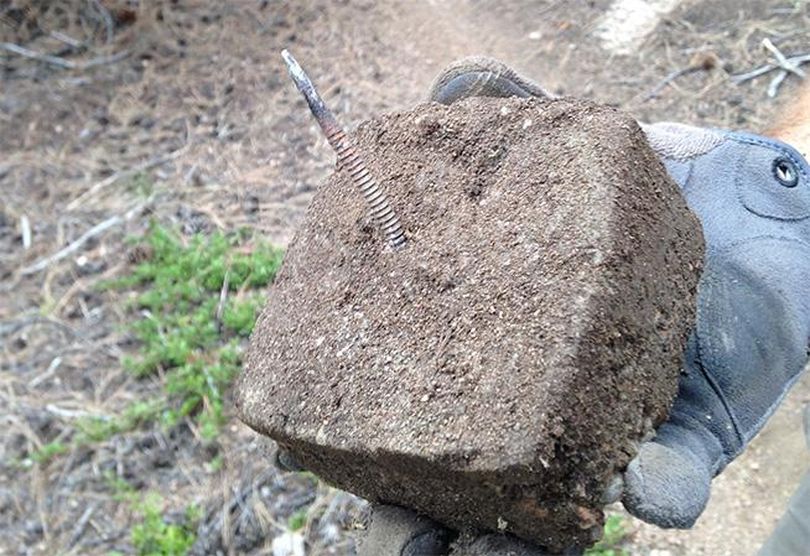 This concrete brick embedded with a 3-inch nail was buried in a Forest Service trail used by mountain bikers in Colorado.  (Tim Fishback)