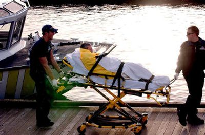 
Members of the Coeur d'Alene Fire Department transport a man  from the Third Street  boat launch on Monday after his kayak  capsized on Lake Coeur d'Alene. 
 (Kathy Plonka / The Spokesman-Review)