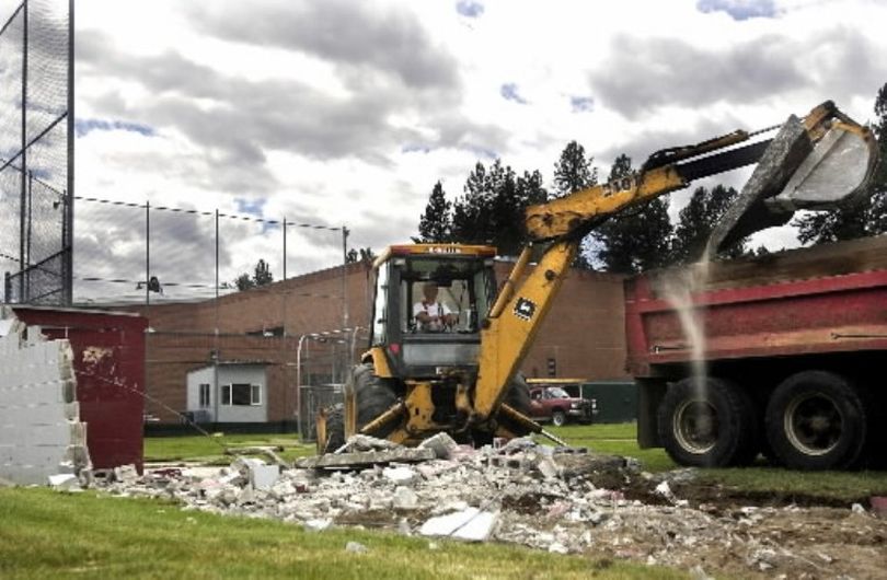 The dugout at the North Idaho College baseball field is demolished in July 2002. The NIC Board of Trustees had eliminated 5 sports programs from NIC offerings in May, including baseball, to balance the budget. The first poem for Huckleberries by The Bard of Sherman Avenue targeted this action by the board of trustees. The college's health and science building now sits on the site of the old baseball field.  (SR file photo: Liz Kishimoto)