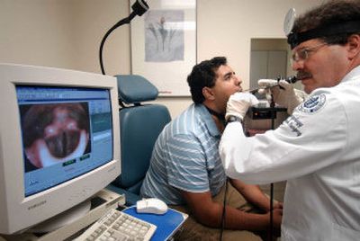 
At the University of Connecticut Health Center in Farmington, Dr. Denis Lafreniere specializes in otolaryngology. Khalid El-Sayed is a pre-med student who can hardly speak. Lafreniere has a TV camera down Khalid's throat showing an image on the computer of his vocal cords.
 (The Hartford Courant / The Spokesman-Review)