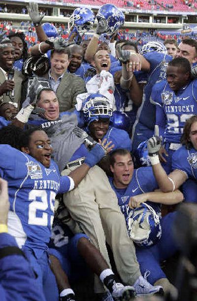 Kentucky players catch coach Rich Brooks in his victory leap. 
 (Associated Press / The Spokesman-Review)