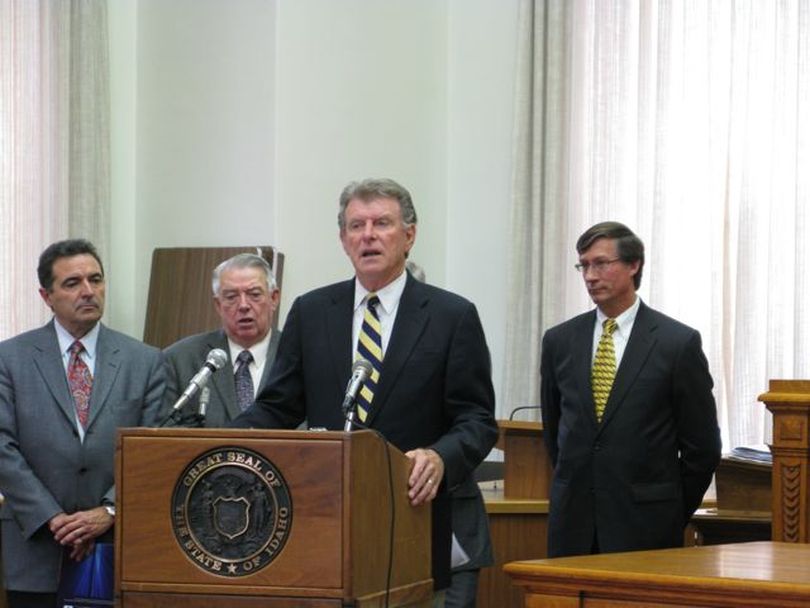 Gov. Butch Otter announces the annual meeting of the Pacific Northwest Economic Region, which will take place in Boise in July and address cross-border issues in the region between the U.S. and Canada that affect the region's global competitiveness. At left is Roy Eiguren, co-chair of the conference host committee, and Rep. Bert Stevenson, R-Rupert; at right is PNWER Executive Director Matt Morrison. (Betsy Russell / The Spokesman-Review)
