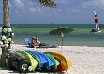
Sea kayaks lie unused on a Key West, Fla., beach while a handful of visitors enjoy the subtropical sun and ocean. 
 (Associated Press photos / The Spokesman-Review)