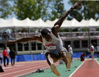 
Kenta Bell, who placed third, soars in the triple jump final during the U.S. Olympic track and field trials in Sacramento, Calif. 
 (Associated Press / The Spokesman-Review)