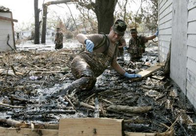 
New Mexico Army National Guard Sgt. 1st Class Chris Andrews pushes through debris during a house to house search in Port Sulphur, La., on Saturday. 
 (Erich Schlegel/ Dallas Morning News / The Spokesman-Review)