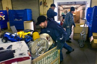 
Jesse Steinfort pushes a cartload of donated goods into the East Sprague facility of Goodwill Industries on Thursday. 
 (Photos by Christopher Anderson/ / The Spokesman-Review)