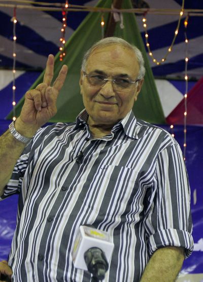 Egyptian presidential candidate Ahmed Shafiq flashes the victory sign to his supporters Friday. (Associated Press)
