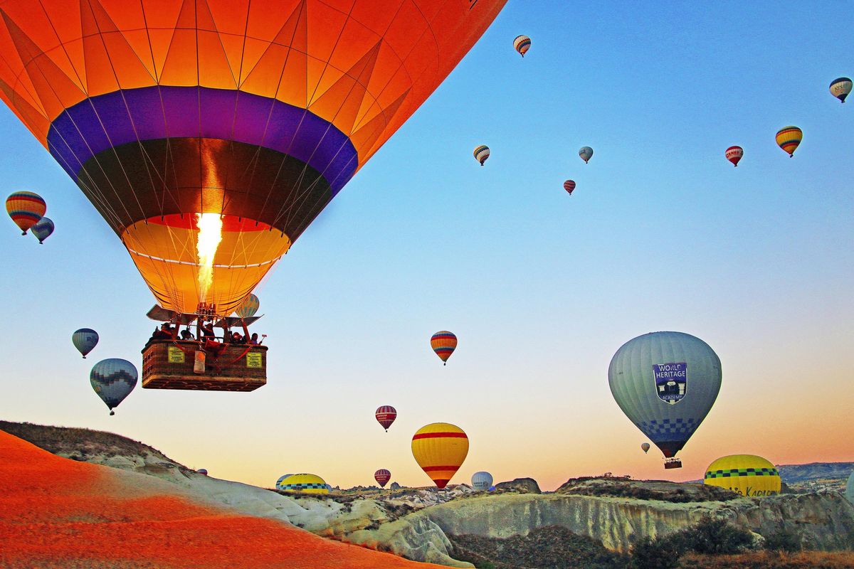 Up, up and away at sunrise in Cappadocia, where hot air balloons drift over a supernatural landscape. (Norma Meyer / Norma Meyer/Tribune News Service)