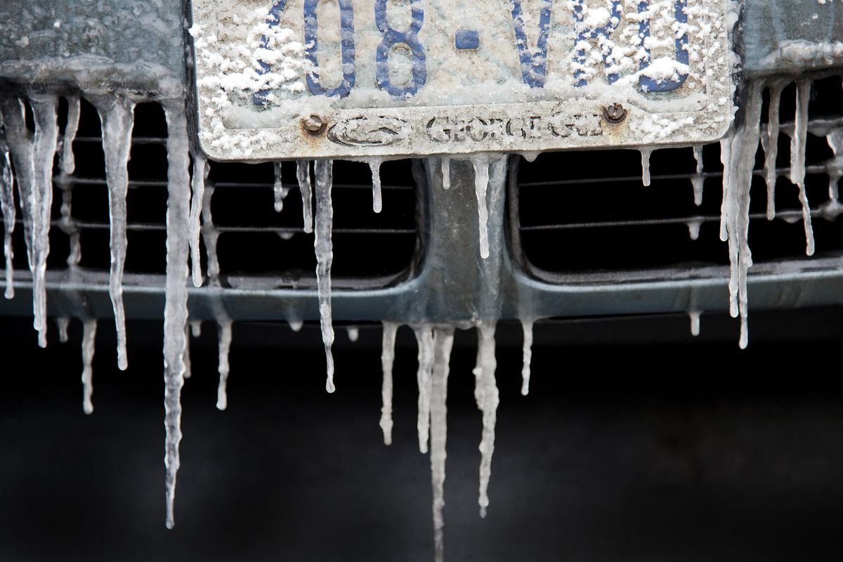 Ice hangs from the bumper of a car parked in a downtown Spokane lot on Tuesday. (Dan Pelle)