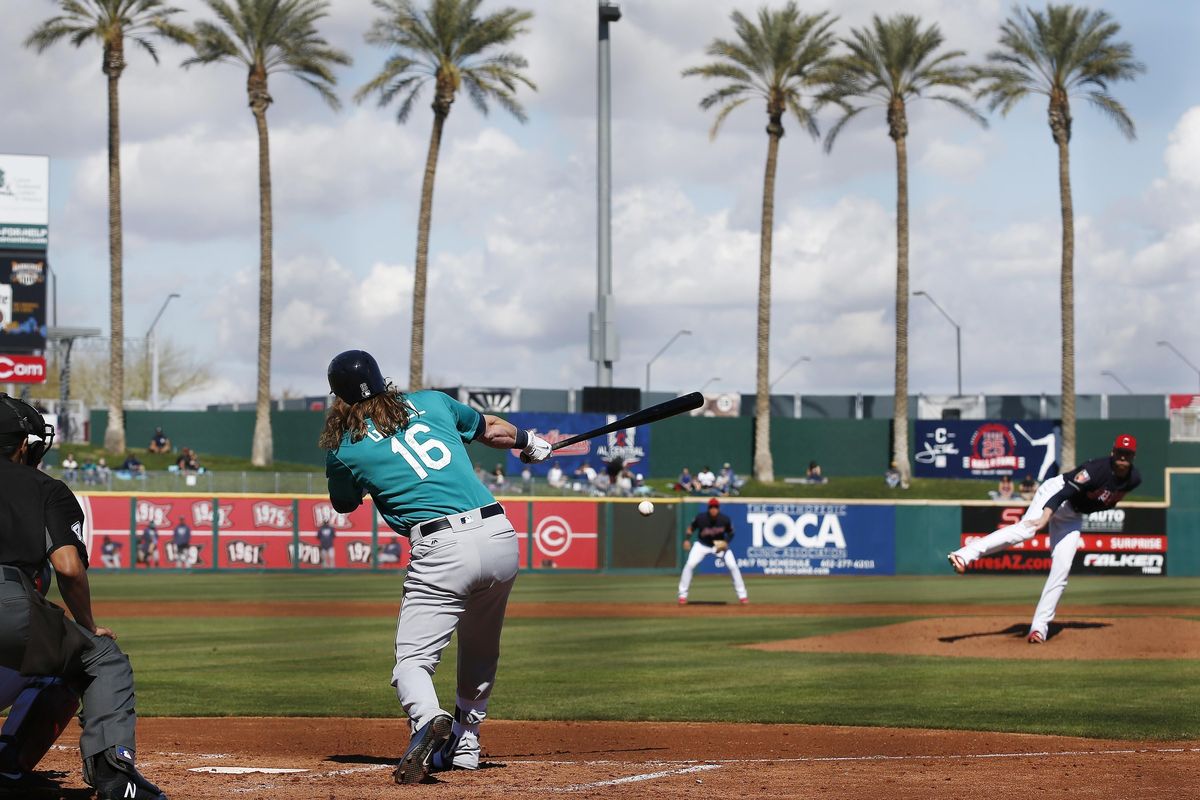 Seattle Mariners’ Ben Gamel (16) hits a grounder back to Cleveland Indians relief pitcher Zach McAllister, right, during the third inning of a spring training baseball game Wednesday, Feb. 28, 2018, in Goodyear, Ariz. (Ross D. Franklin / Associated Press)