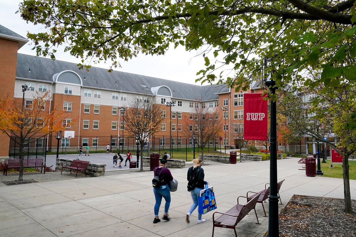 FILE - Students walk on the campus of Indiana University of Pennsylvania in Indiana, Pa., Oct. 21, 2020. The Biden administration on Wednesday, Dec. 22, 2021, extended a student loan moratorium that has allowed millions of Americans to put off debt payments during the pandemic. Under the action, payments on federal student loans will remain paused through May 1, 2022. (Gene J. Puskar)