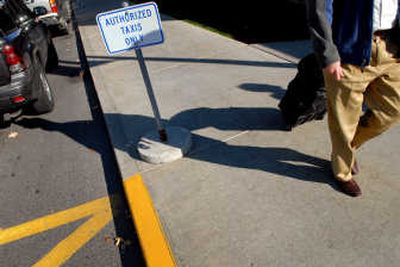 
Passengers and vehicles pass through a taxi stand Thursday at Spokane International Airport. Spokane Cab will now handle business that TC Transportation Services provided at the airport. 
 (Brian Plonka / The Spokesman-Review)