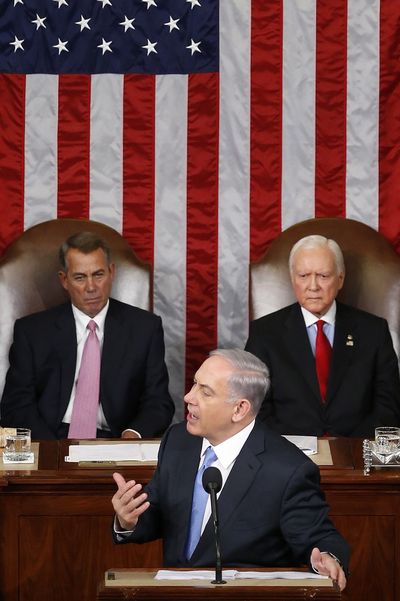 Israeli Prime Minister Benjamin Netanyahu speaks before a joint meeting of Congress on Capitol Hill in Washington on Tuesday. House Speaker John Boehner, left, and Sen. Orrin Hatch listen. (Associated Press)