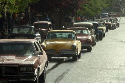 
Cars move down Sherman Avenue in Coeur d'Alene in spite of a rainstorm that accompanied the beginning of the Car d'Lane cruise Friday evening. 
 (The Spokesman-Review)