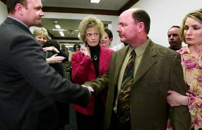 
Ozzie Knezovich, left, shakes the hand of Cal Walker, one of his opponents, after being named Spokane County Sheriff on Tuesday evening April 11, 2006, at the Spokane County Courthouse.
 (Kathryn Stevens / The Spokesman-Review)