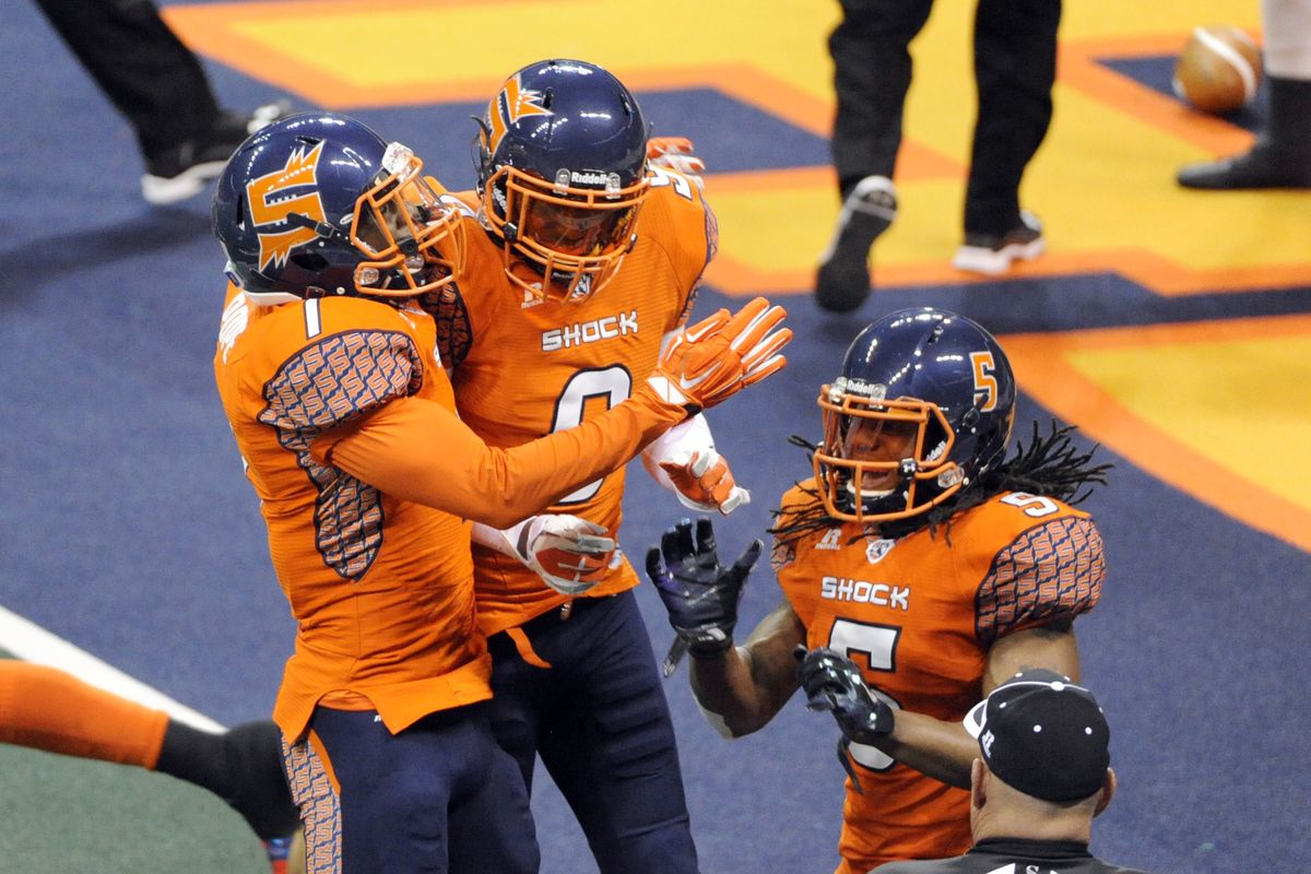Shock’s Sergio Gilliam, center, celebrates with teammates Sam Pope, left, and Anthony Amos after his first-half kick return for a touchdown on Friday at the Arena. (Jesse Tinsley)