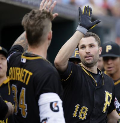 Pirates' Neil Walker, right, receives a high-five from pitcher A.J. Burnett after hitting first of two homers. (Associated Press)