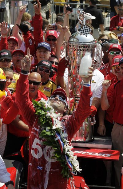 Dario Franchitti raises a milk toast to his late friend Dan Wheldon. Franchitti, Scott Dixon and Tony Kanaan, Wheldon’s three closest friends in the IndyCar Series finished 1-2-3 in the Indianapolis 500. (Associated Press)