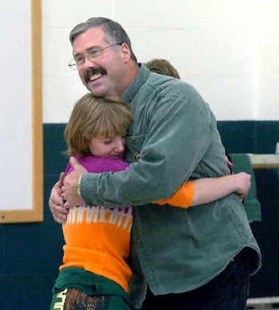 
Marty Coon, a bus driver who drops kids at Winton Elementary, hugs Brittany Reese, a fifth-grader, after Reese announced that she had nominated him for an award. 
 (Jesse Tinsley / The Spokesman-Review)