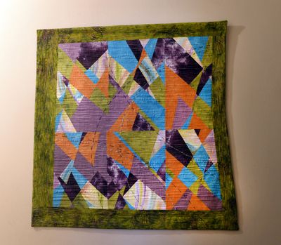 Pam Hansen created this wall hanging with striking colors and textures and an asymetrical shape.