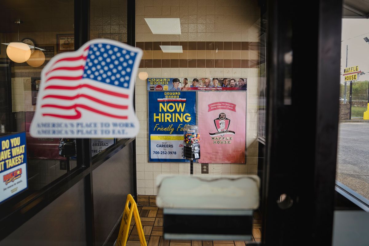 A view through a glass doorway on Thursday at the Waffle House on Martha Berry Highway in Rome, Ga. Gregg Phillips, the Federal Emergency Management Agency official in charge of responding to fires and floods, says the hand of God suddenly and mysteriously moved him to the 24-hour breakfast spot.  (Nicole Craine/The New York Times)