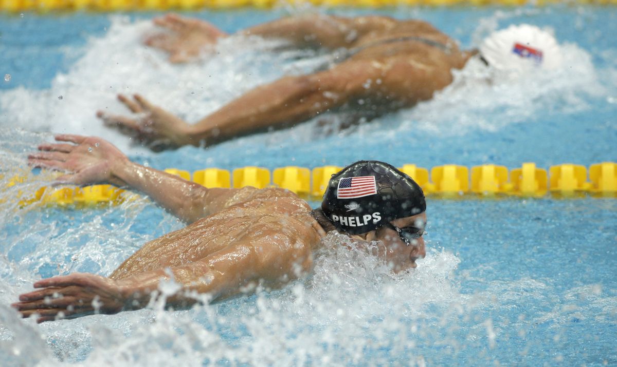 Michael Phelps, front, swims beside of Serbia’s Milorad Cavic in the 100-meter butterfly final.  (Associated Press / The Spokesman-Review)