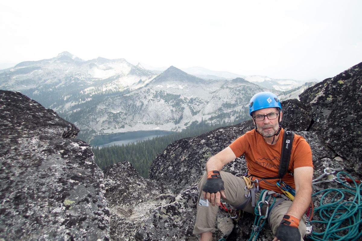 Charlie LaBrie, 58, sits atop Harrison Peak in North Idaho in July. (Eli Francovich / The Spokesman-Review)