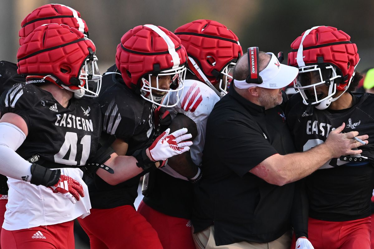 Eastern Washington Eagles head coach Aaron Best celebrates with safety JoJo Maxey-Johnson (34) after he intercepted a pass during EWU’s 2025 Red-White Game on Friday, Apr. 18, 2025, on Roos Field in Cheney, Wash.  (Tyler Tjomsland/The Spokesman-Review)