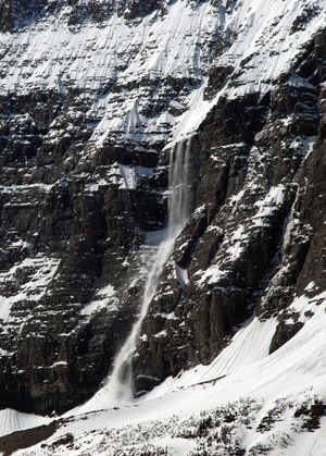 Soon after the morning sun warms east-facing slopes, avalanches begin
cascading like waterfalls down the steep slopes of cirque basins,
booming and echoing, in Glacier National Park.  (Rich Landers / The Spokesman-Review)